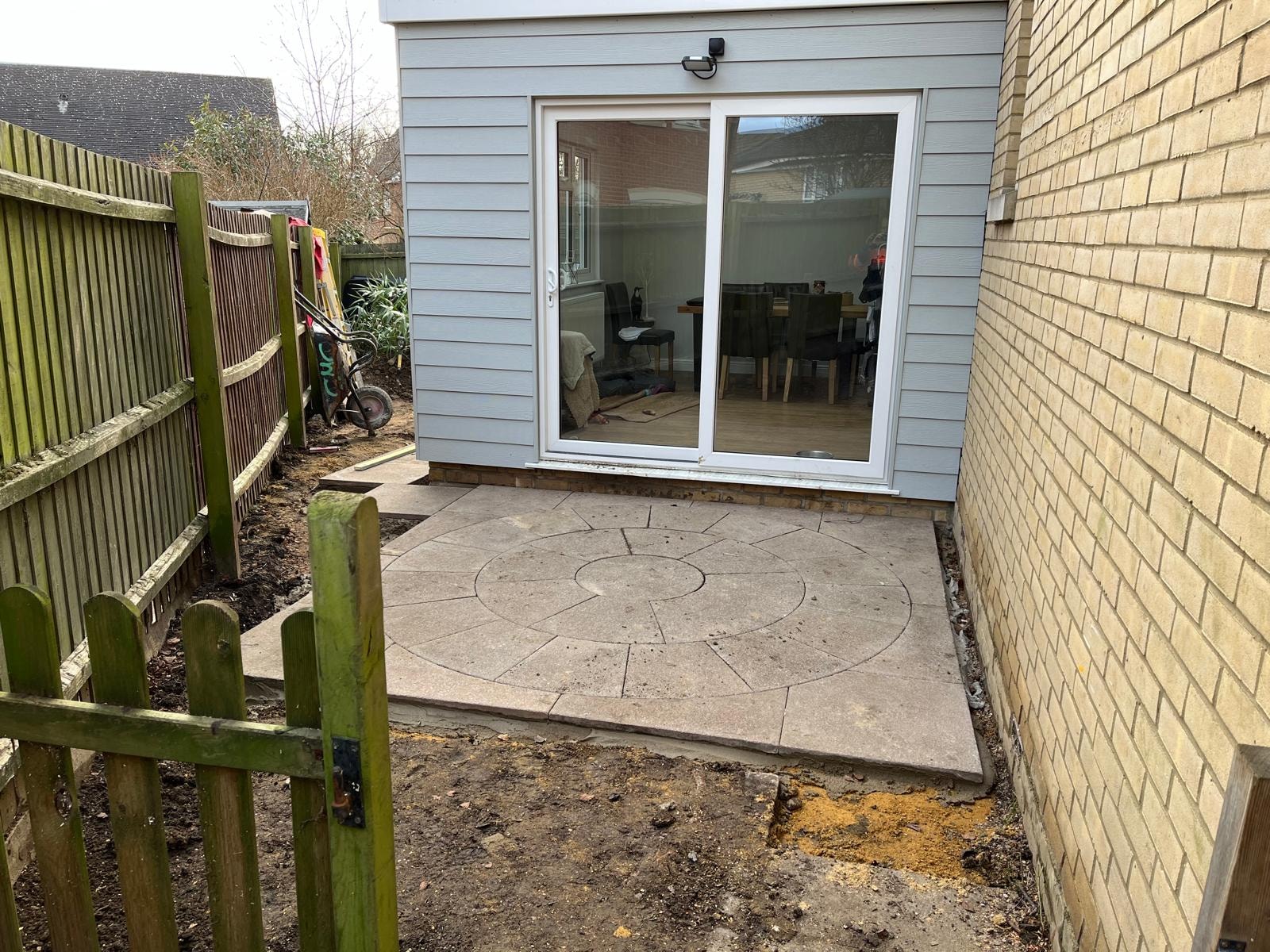 Completed garden room extension with patio and sliding doors
