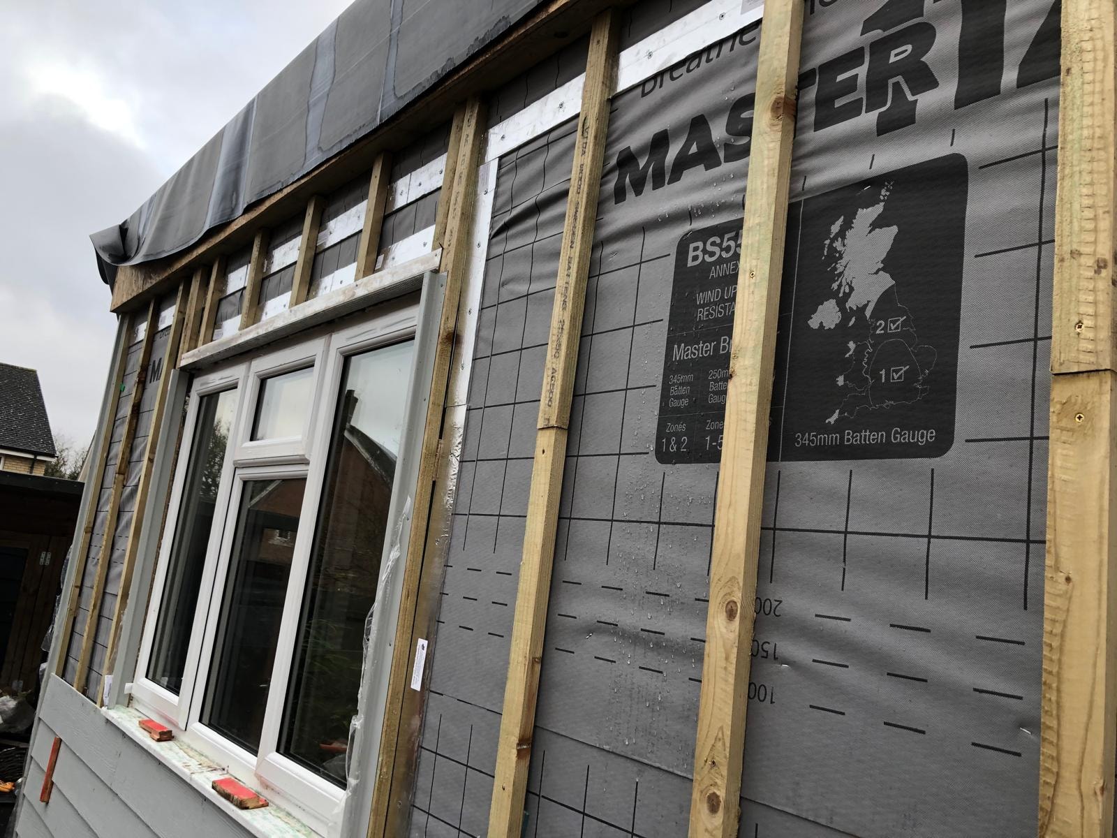 Extension in progress — breathable membrane and window installation